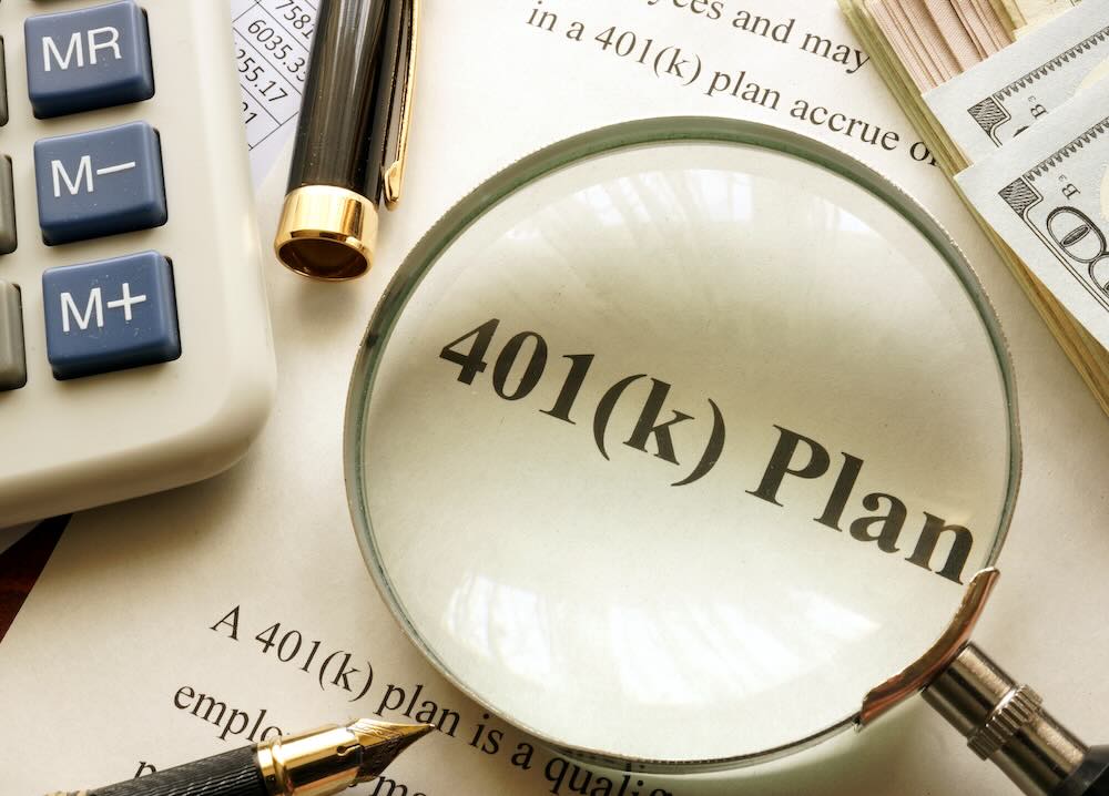 Document with title 401k plan on a table.
